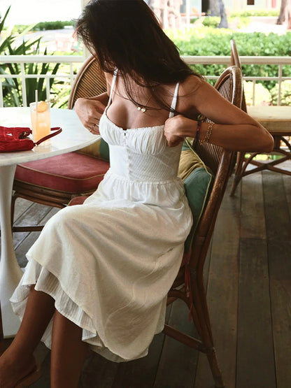 Iris | Solid color midi dress with thin straps and ruffle at the hem